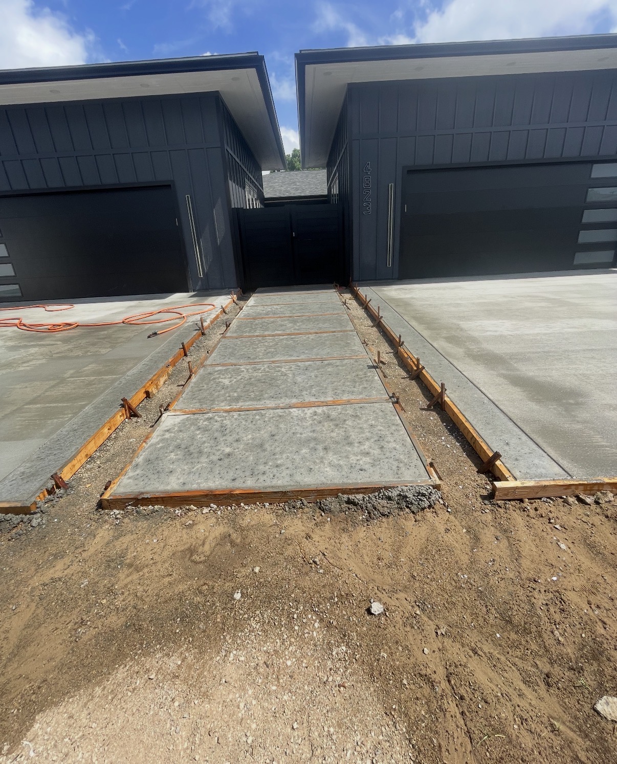 Concrete walkway between two driveway slabs