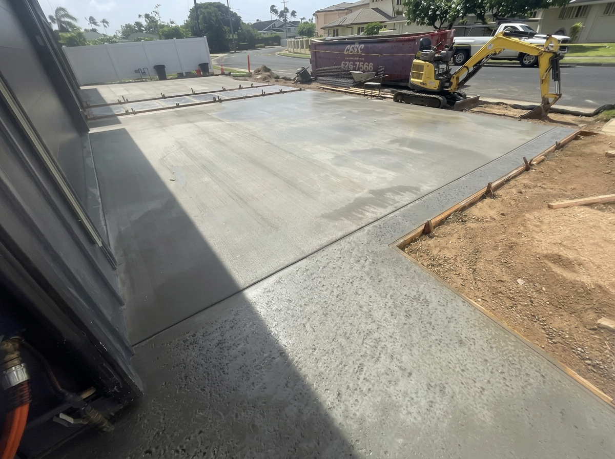 Freshly placed concrete driveway beside the garage